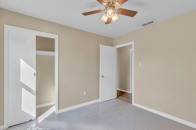 unfurnished bedroom featuring ceiling fan and light carpet