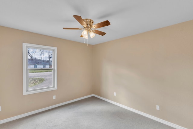 carpeted empty room featuring ceiling fan