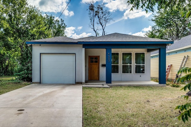 view of front of home featuring a garage and a front lawn