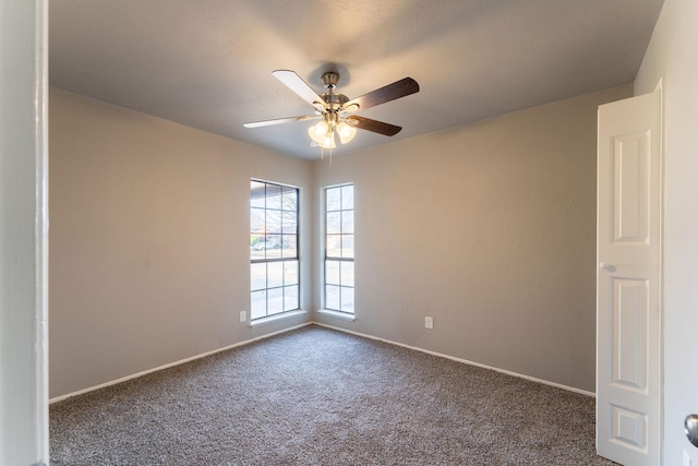 carpeted spare room with ceiling fan