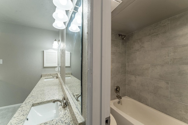 bathroom with vanity and tiled shower / bath combo