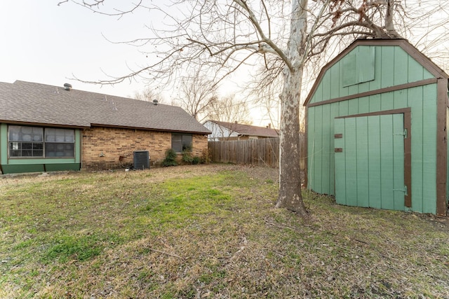 view of yard with a storage shed and central air condition unit