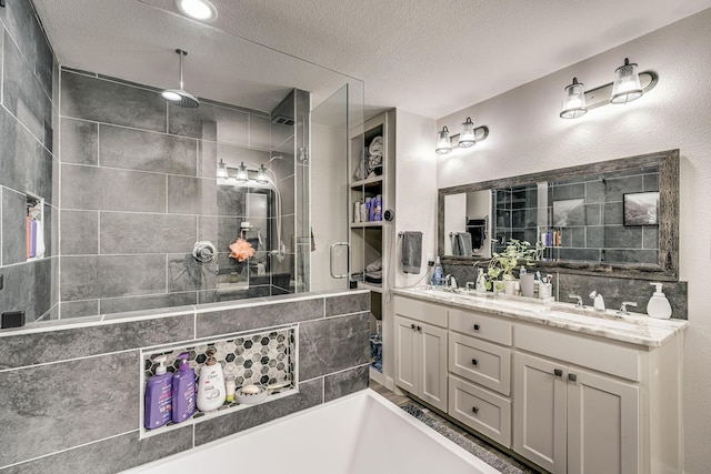 bathroom with vanity, plus walk in shower, and a textured ceiling