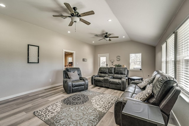 living room featuring vaulted ceiling and light wood-type flooring