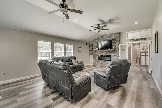 205 Newman Rd, Ennis, TX 75119 - living area featuring a ceiling fan, wood finished floors, a stone fireplace, vaulted ceiling, and baseboards