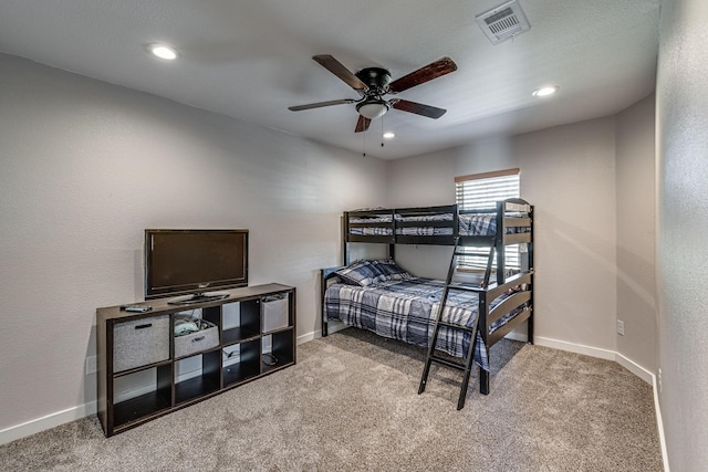 bedroom featuring ceiling fan and carpet