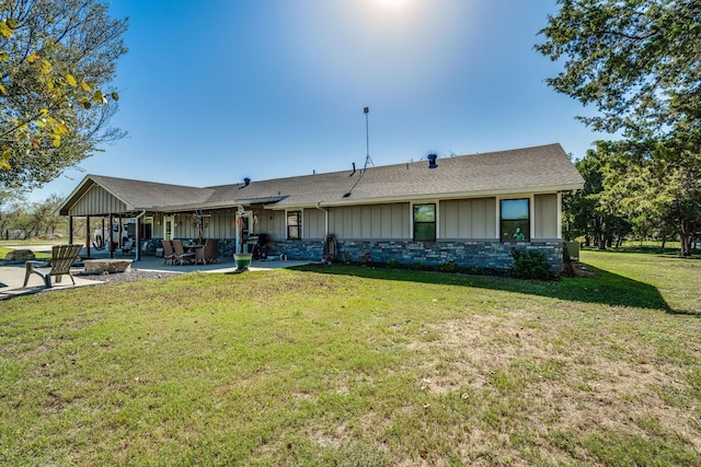 view of front facade with a front lawn and a patio area