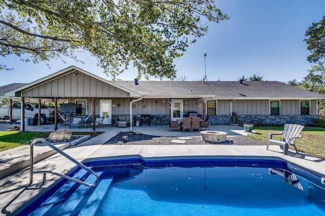 back of house featuring a fire pit and a patio area