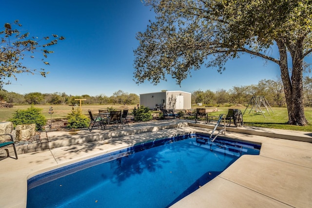 view of swimming pool with a yard and a patio