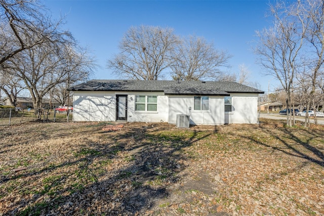 back of house featuring cooling unit and a lawn