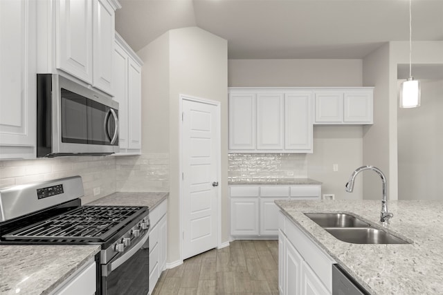 kitchen with sink, stainless steel appliances, and white cabinets