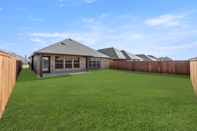 rear view of house featuring a lawn