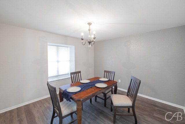 dining room featuring dark hardwood / wood-style flooring and a chandelier