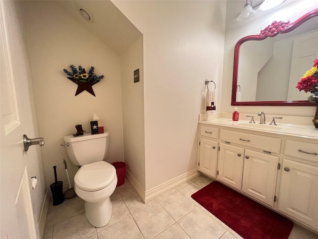 bathroom with vanity, toilet, and tile patterned flooring