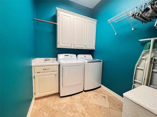 laundry area featuring cabinets, sink, and washing machine and dryer