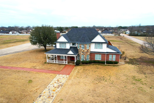 view of front of house with a front yard and covered porch