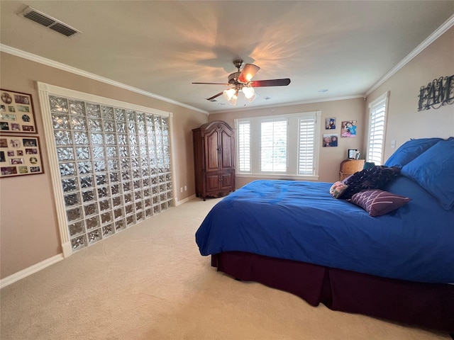 carpeted bedroom featuring crown molding and ceiling fan