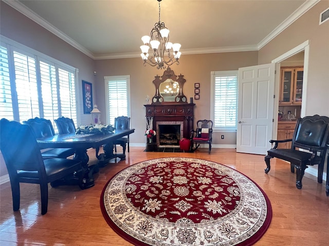 interior space featuring crown molding, a fireplace, and a wealth of natural light