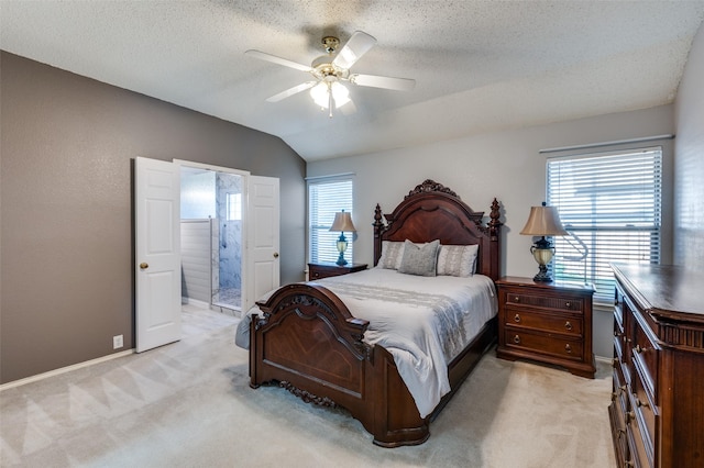 bedroom with lofted ceiling, light carpet, and a textured ceiling