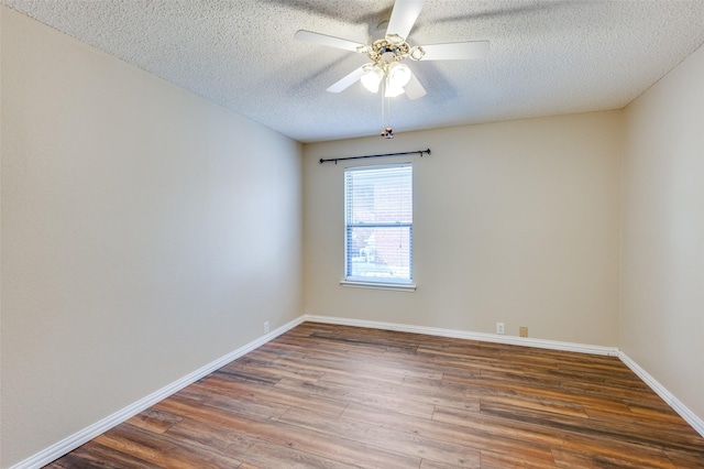 unfurnished room featuring ceiling fan, a textured ceiling, and dark hardwood / wood-style flooring