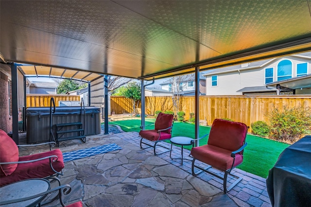 view of patio / terrace with a hot tub