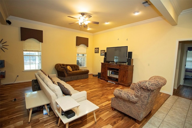 living room featuring ceiling fan, ornamental molding, and light hardwood / wood-style floors