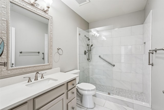 bathroom with vanity, a shower with shower door, and toilet