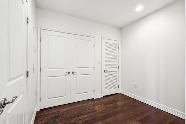 unfurnished bedroom with dark hardwood / wood-style floors