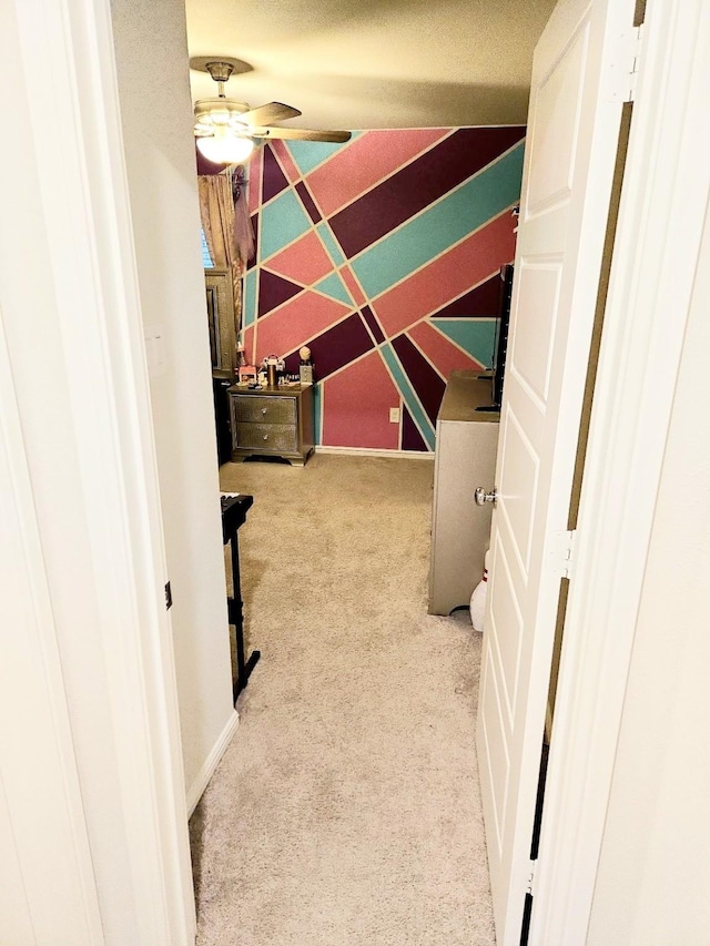 spacious closet featuring light colored carpet and ceiling fan