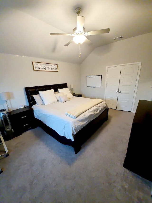 carpeted bedroom featuring ceiling fan, lofted ceiling, and a closet