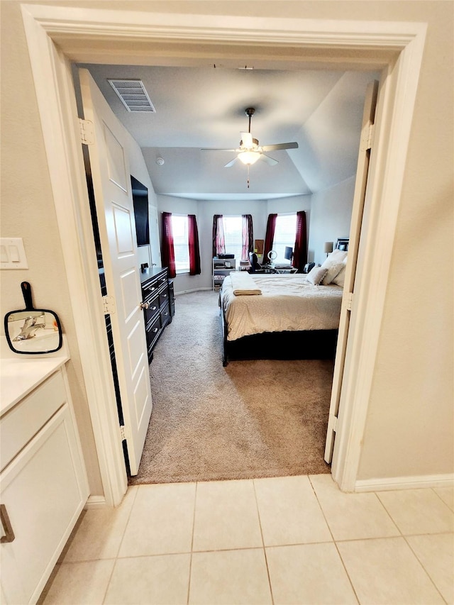 bedroom featuring ceiling fan and light carpet