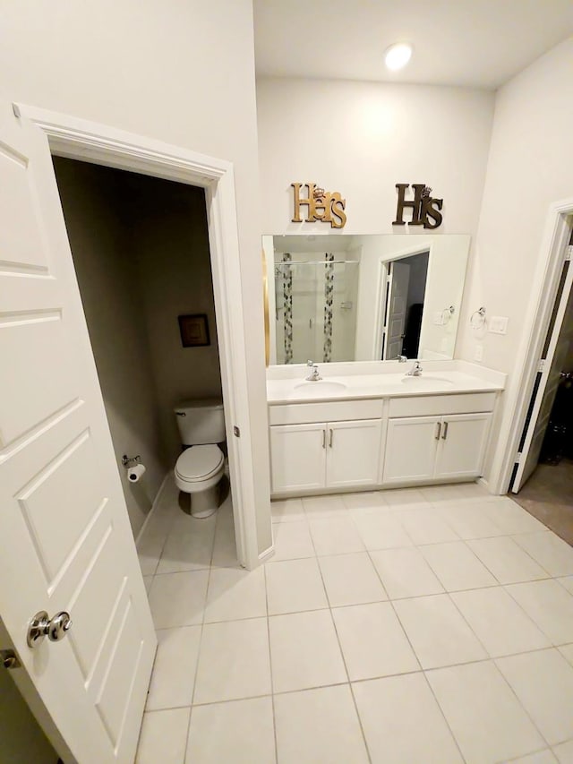 bathroom with vanity, toilet, an enclosed shower, and tile patterned flooring