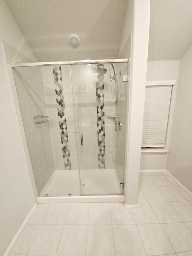 bathroom with walk in shower and tile patterned floors