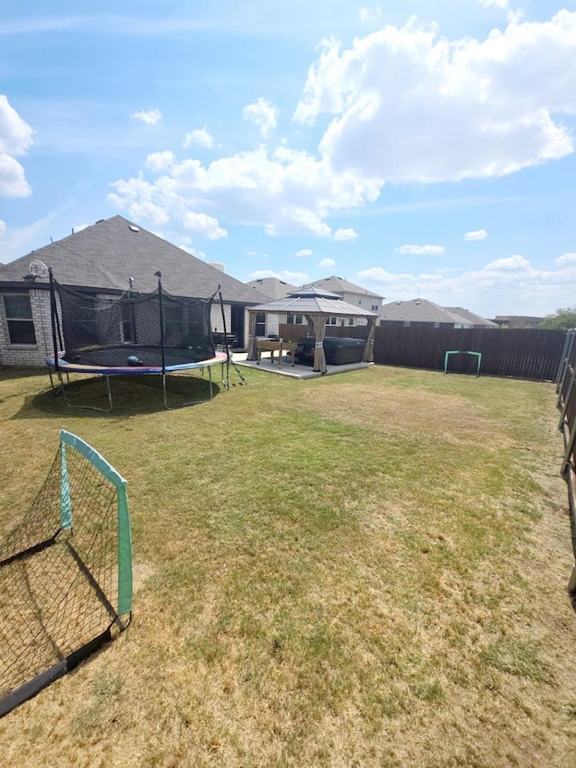 view of yard featuring a gazebo and a trampoline