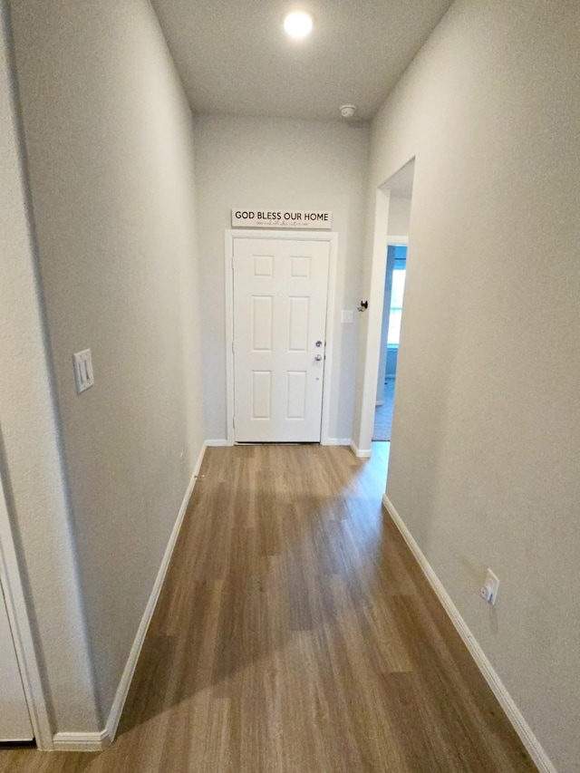 hall with wood-type flooring