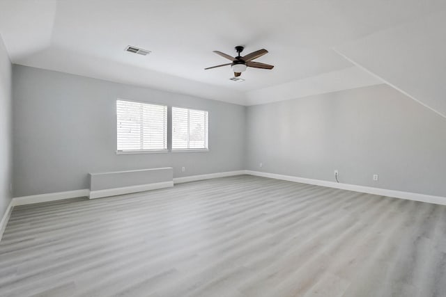 spare room featuring light hardwood / wood-style flooring and ceiling fan