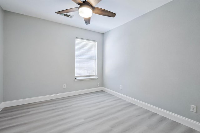 spare room featuring light wood-type flooring and ceiling fan