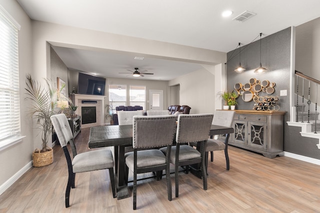 dining room featuring wood-type flooring and ceiling fan