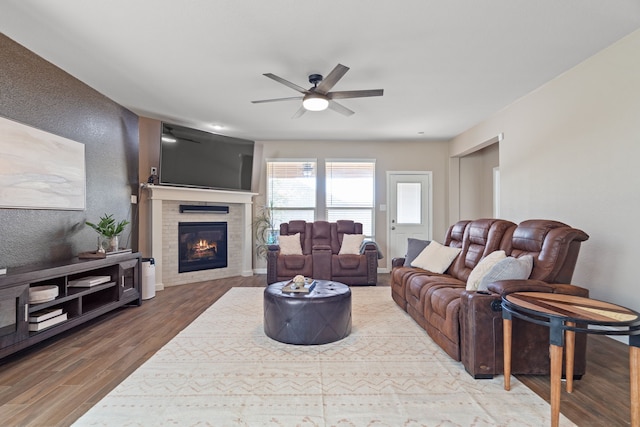 living room with wood-type flooring and ceiling fan