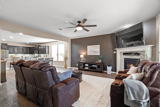 living room with hardwood / wood-style flooring and ceiling fan