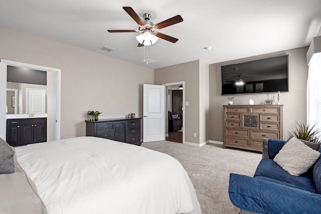 carpeted bedroom with ceiling fan, ensuite bathroom, and sink