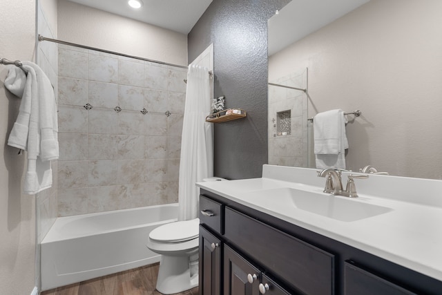 full bathroom with vanity, hardwood / wood-style floors, toilet, and shower / bath combo with shower curtain