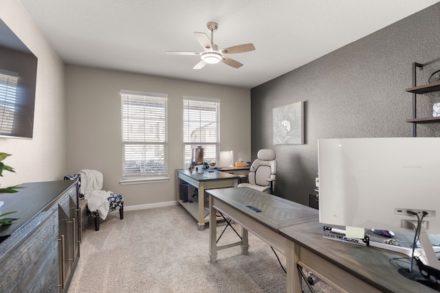 carpeted office space featuring ceiling fan