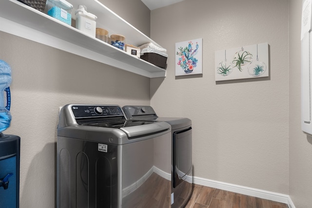 laundry room featuring dark wood-type flooring and washer and clothes dryer