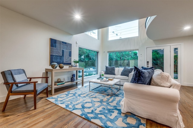 living room with a high ceiling and light wood-type flooring