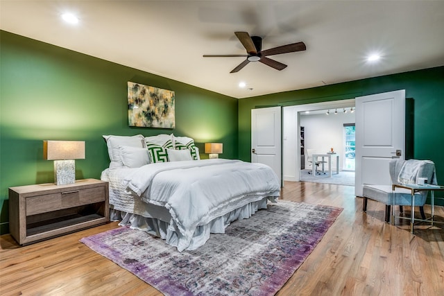 bedroom with ceiling fan and light wood-type flooring