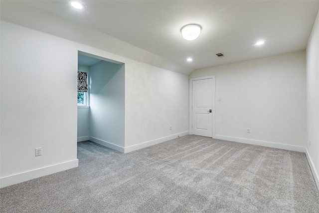 unfurnished room with lofted ceiling and carpet