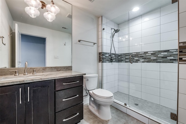 bathroom with vanity, walk in shower, tile patterned floors, and toilet