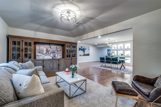 living room featuring wood-type flooring and a chandelier