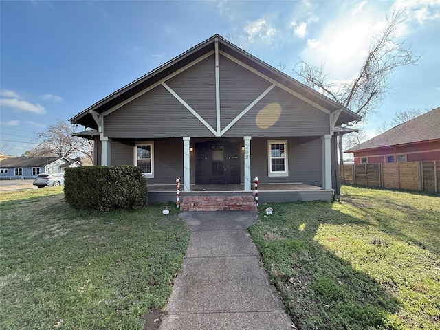 bungalow-style house with covered porch and a front yard